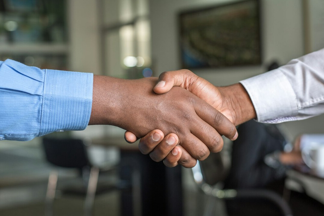 business handshake across table
